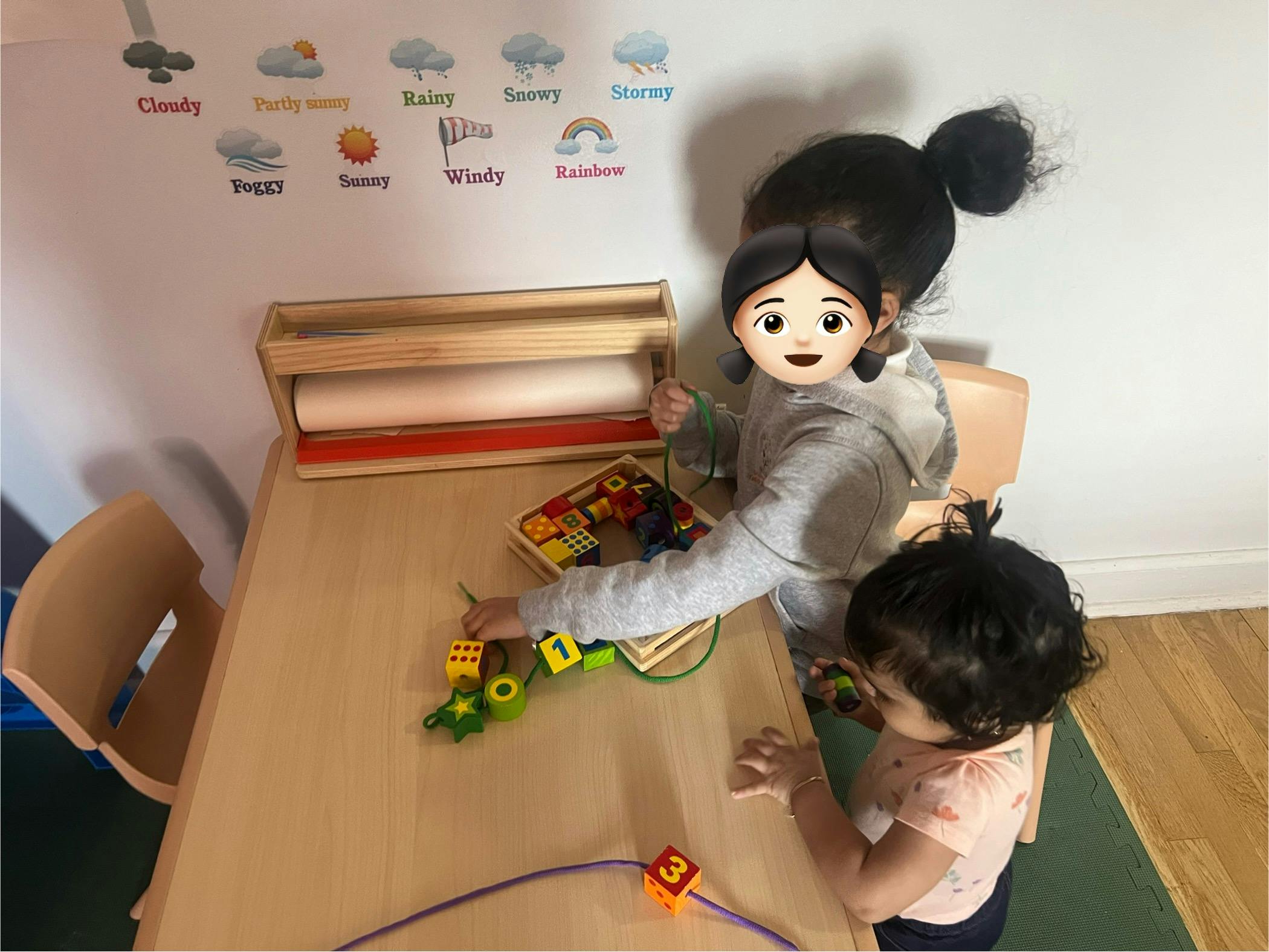 Two children playing with toys at a table