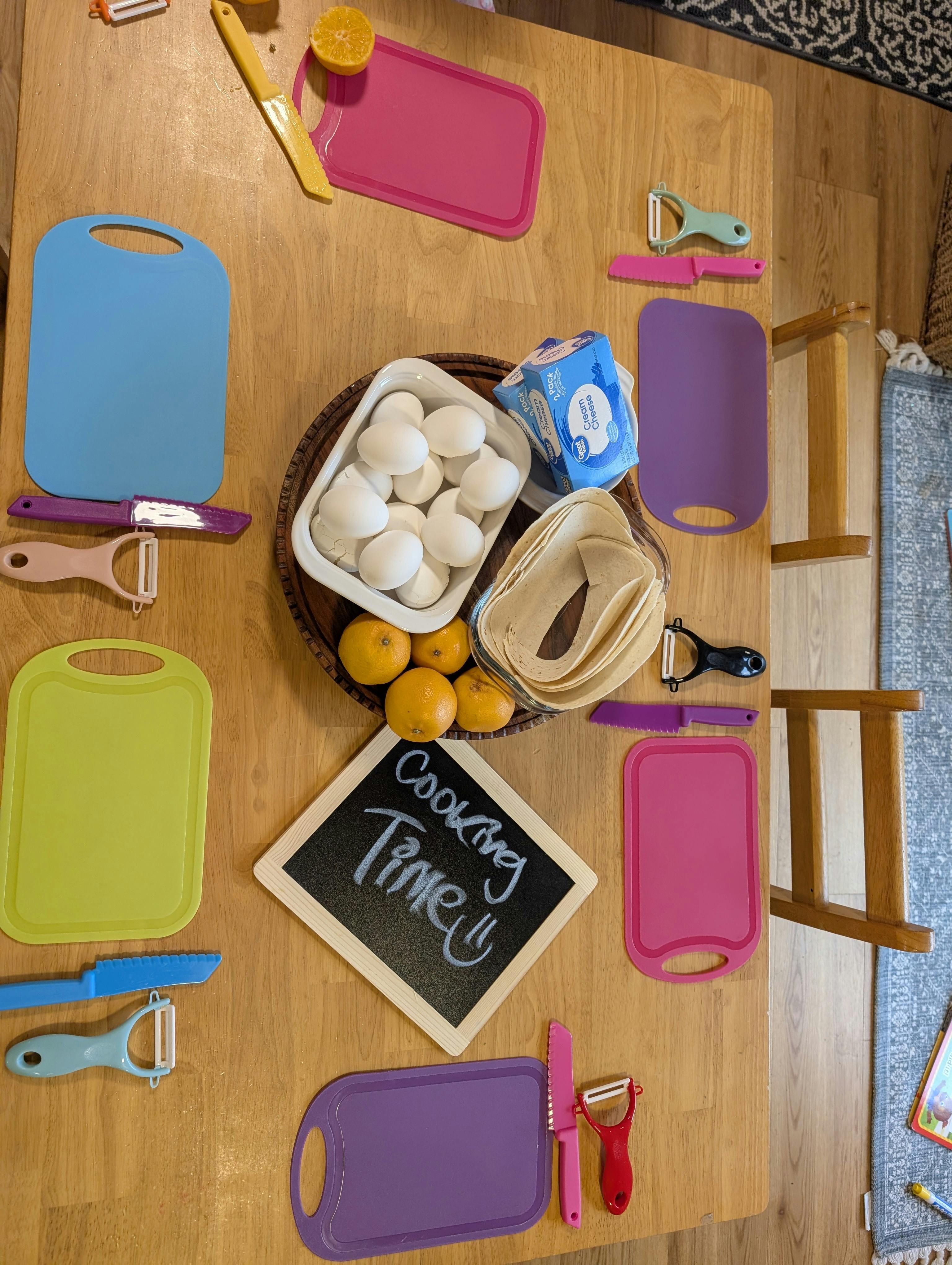 Cooking time sign with eggs, tortillas, cream cheese, and small cutting boards