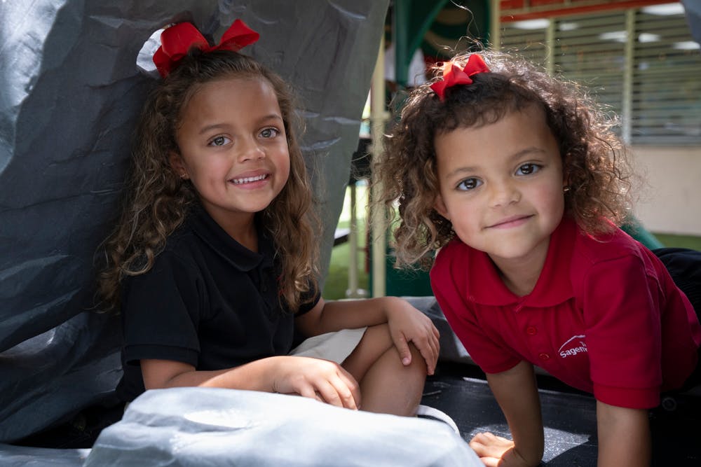 Two children with red bows in their hair