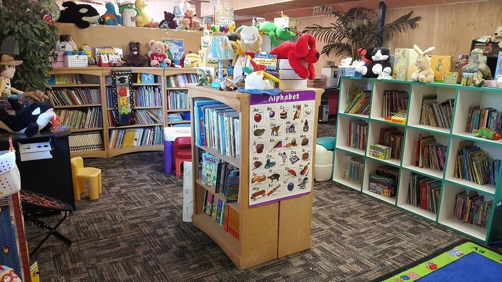 Children's library with bookshelves and an alphabet chart