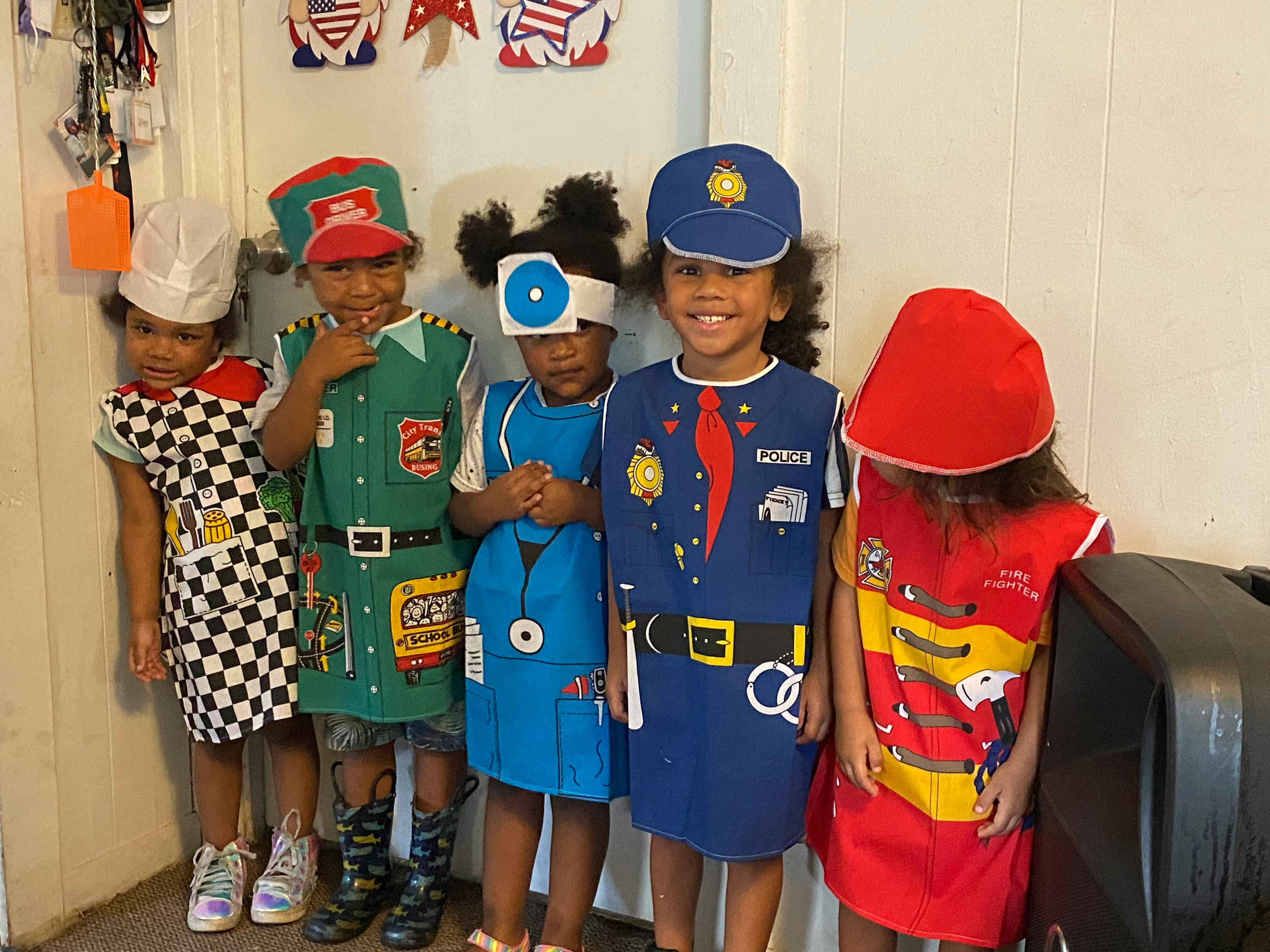 Five children in various career costumes
