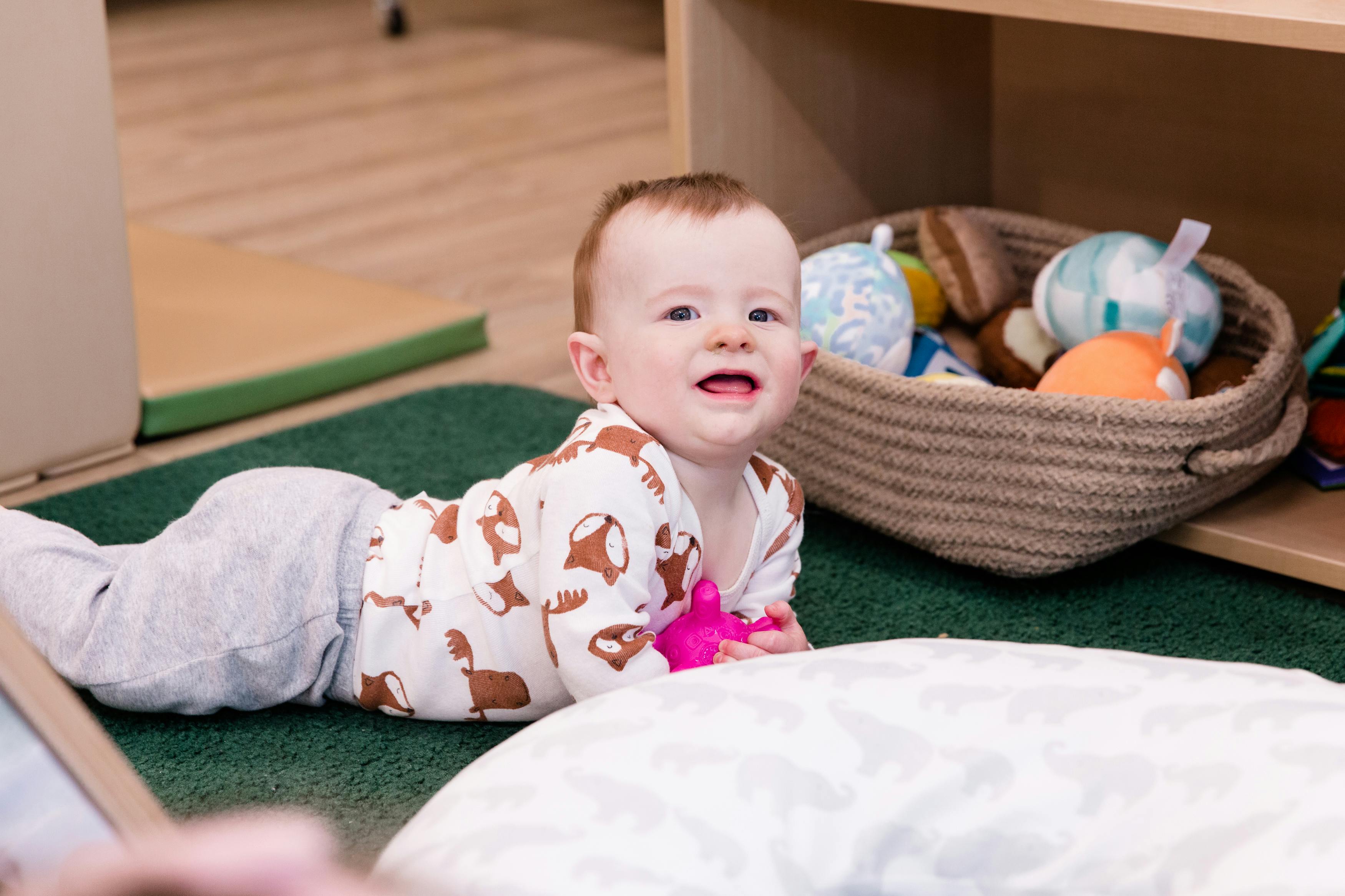 Child crawling on a green rug