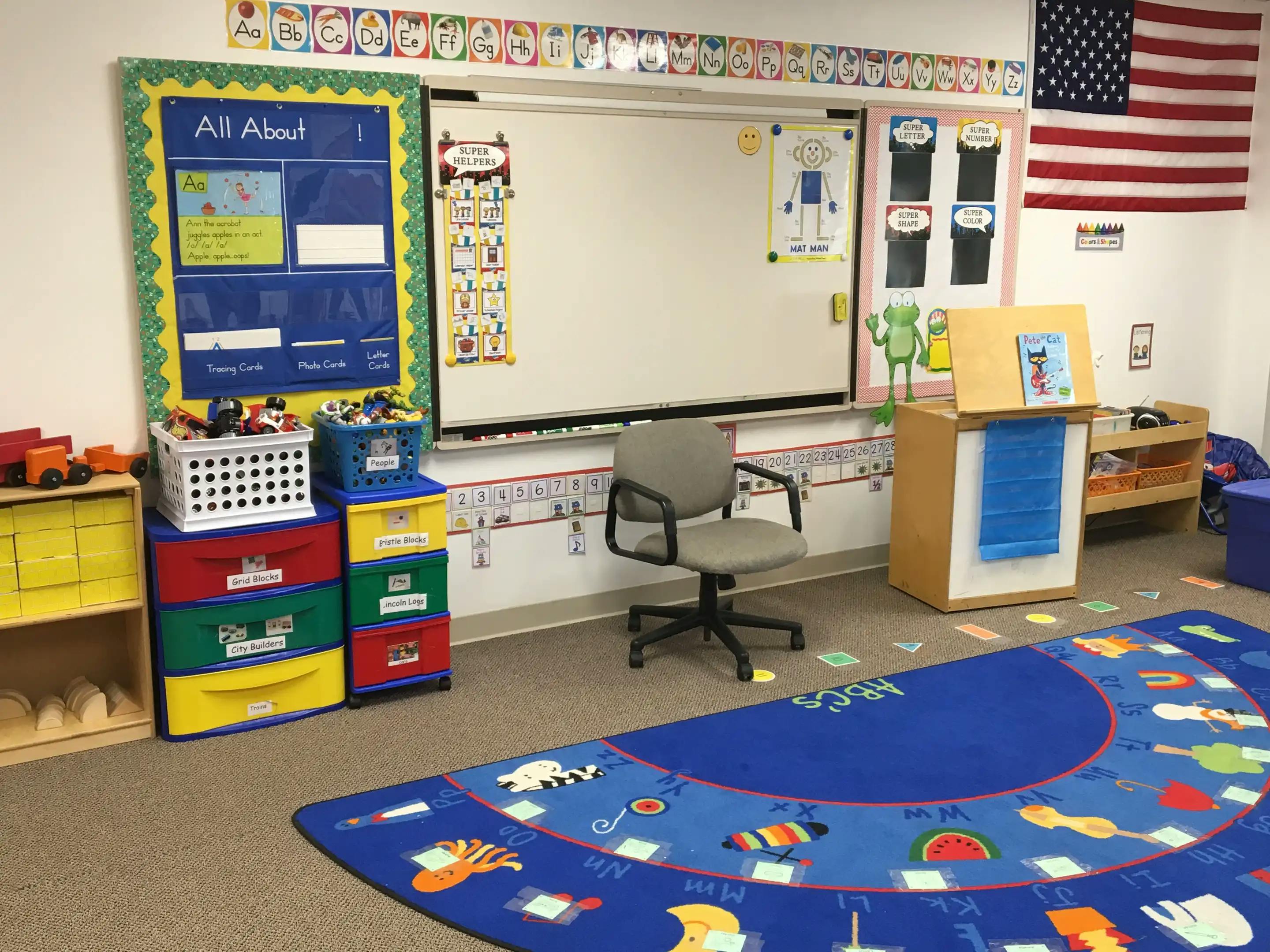 Classroom with a whiteboard, colorful storage, and a blue rug