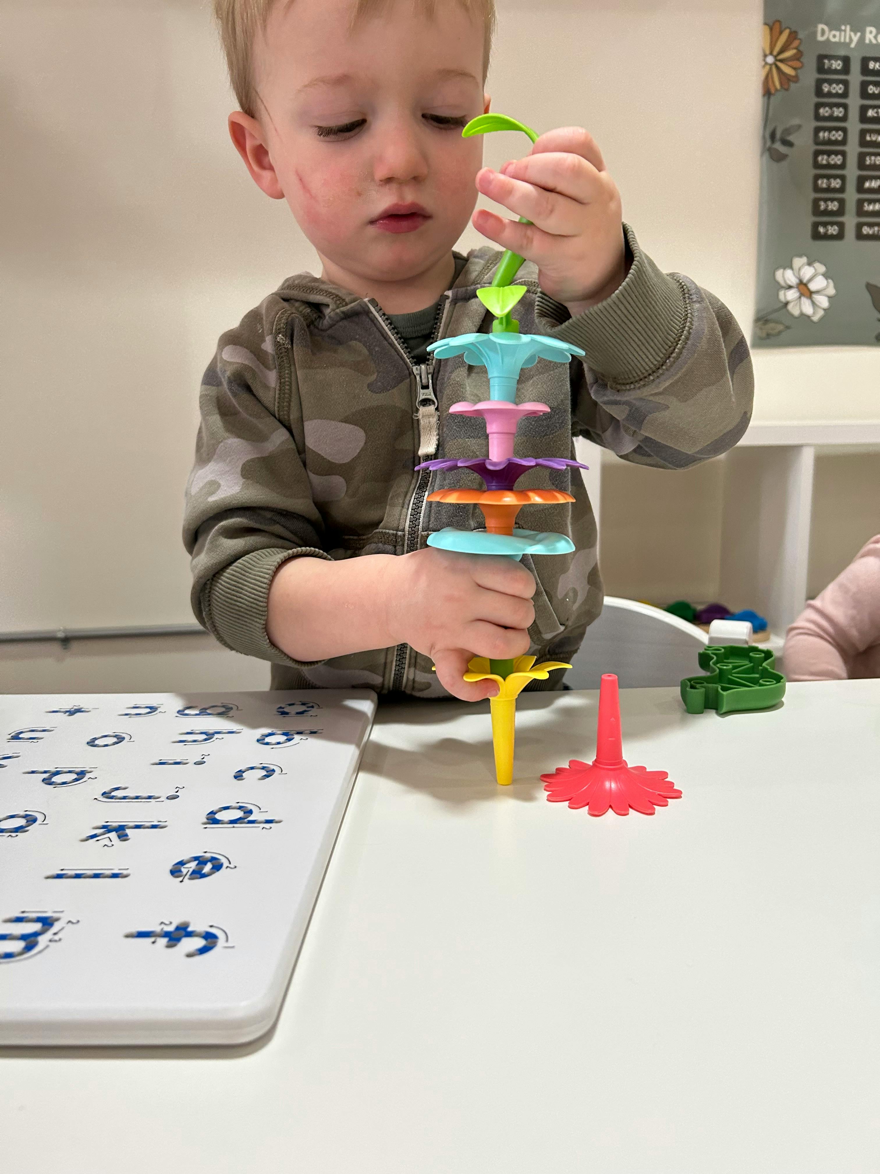 Child playing with a colorful stacking toy