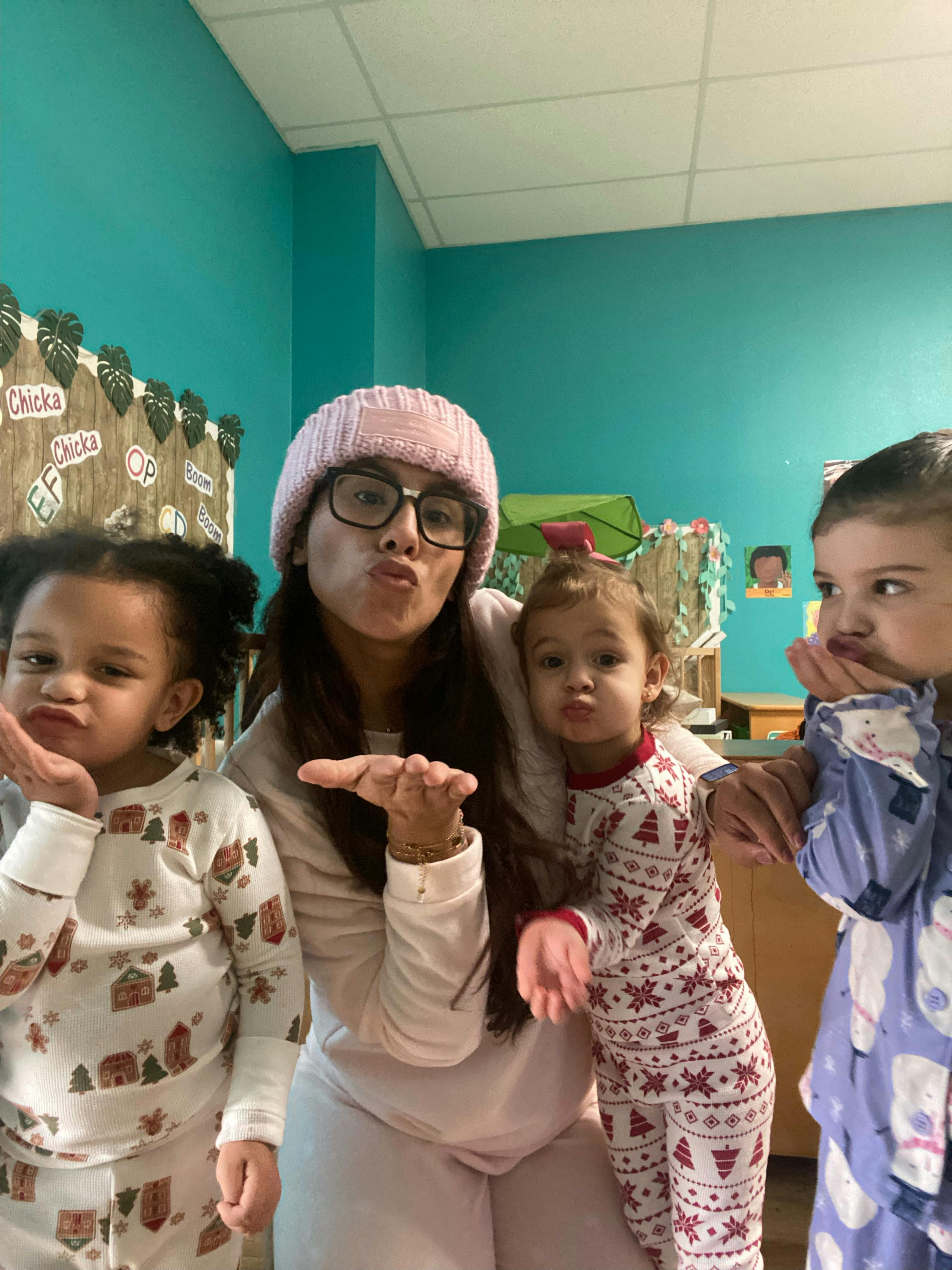 Person and two children making kissy faces and blowing kisses