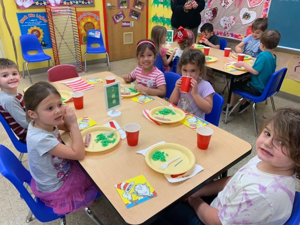 Children sitting at tables in a classroom