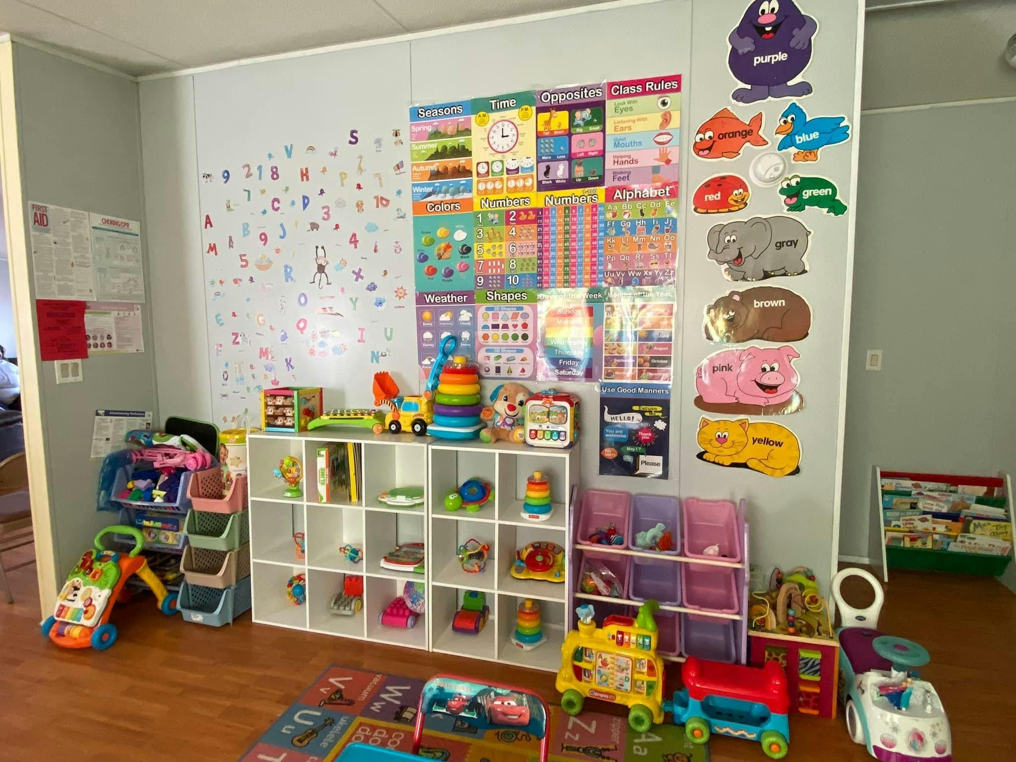 Playroom with shelves of toys, colorful charts on the wall