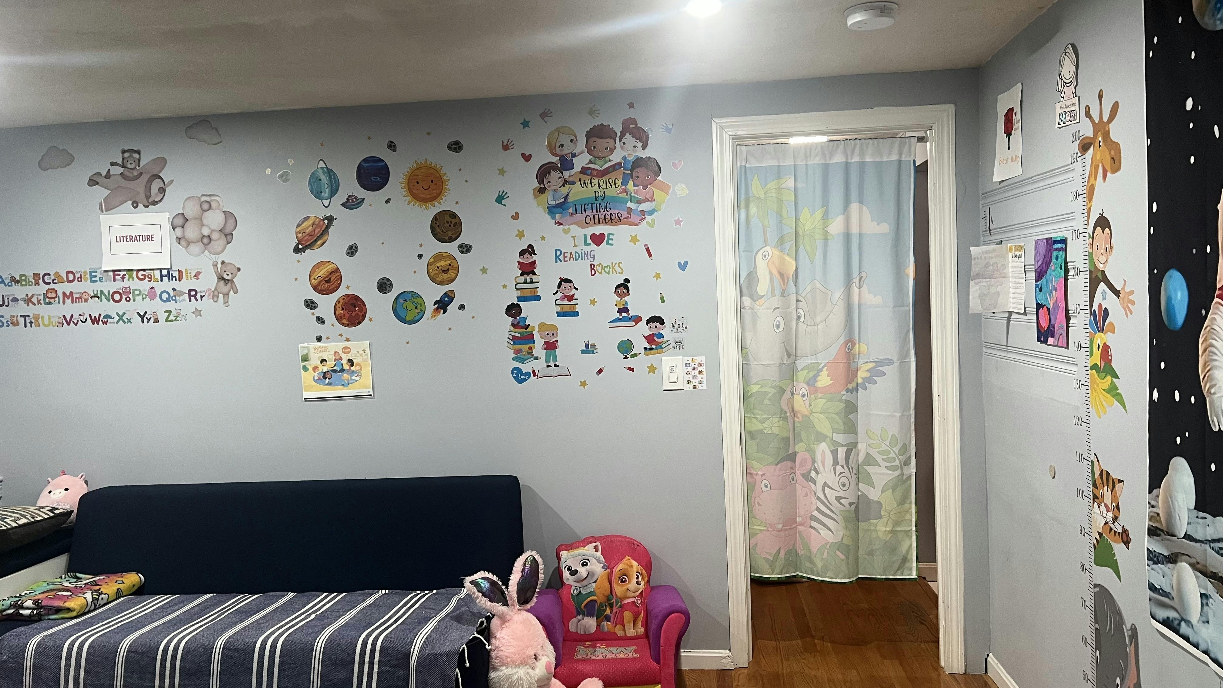 Child bedroom wall decorated with space stickers and reading themed wall decals