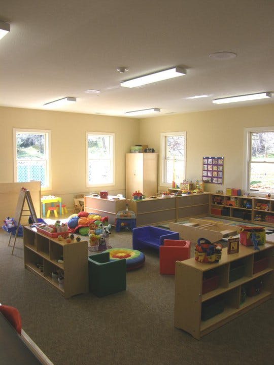 Playroom with various toys, furniture, and shelves