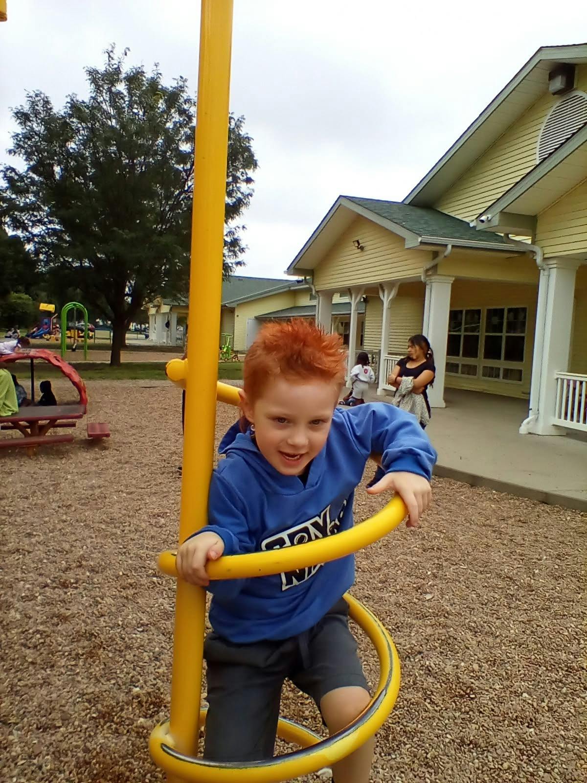 Child playing on a spiral playground climber