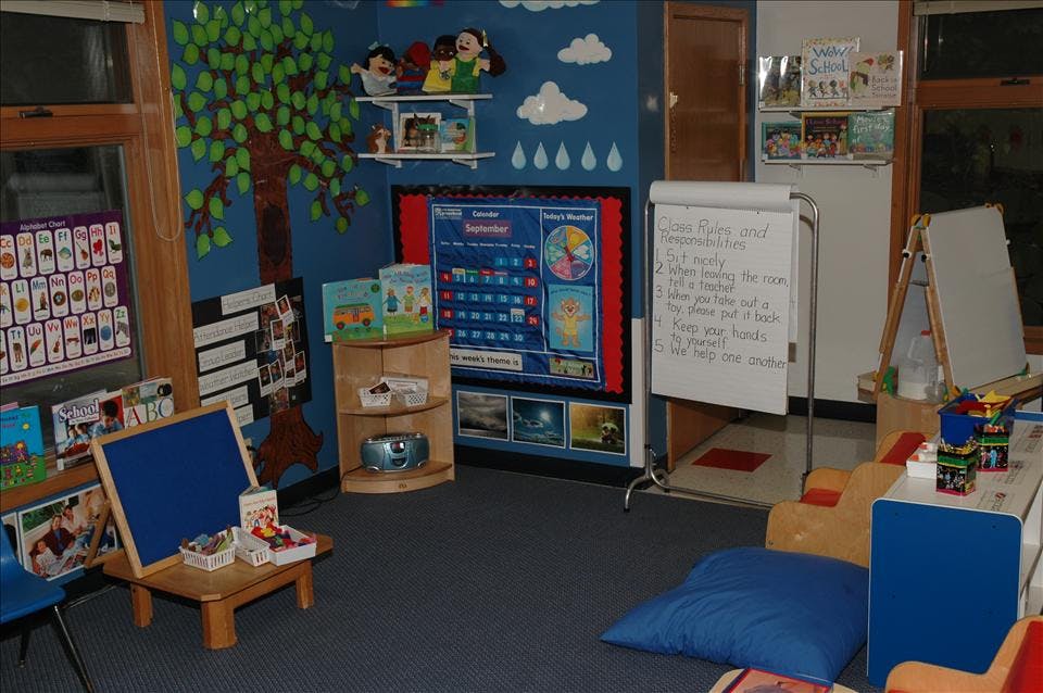 Classroom corner with an alphabet chart, calendar, and a whiteboard with class rules