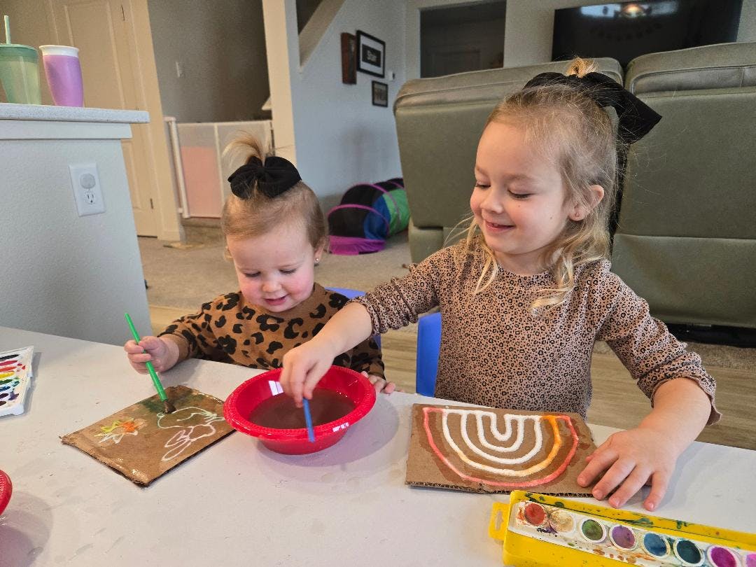 Two children painting with watercolors