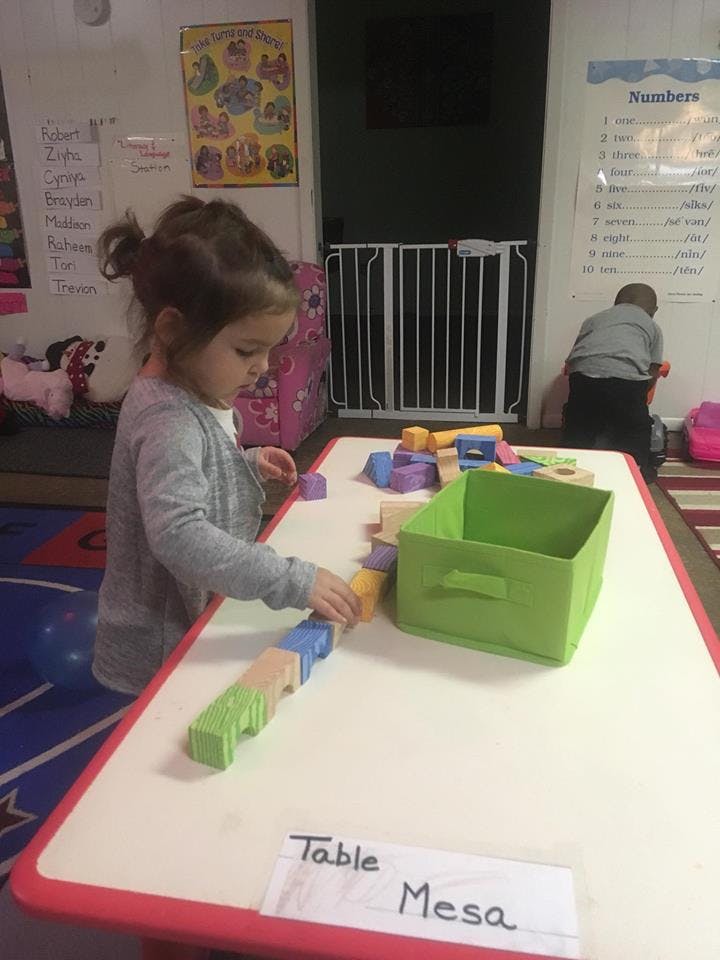 Child playing with blocks at a table