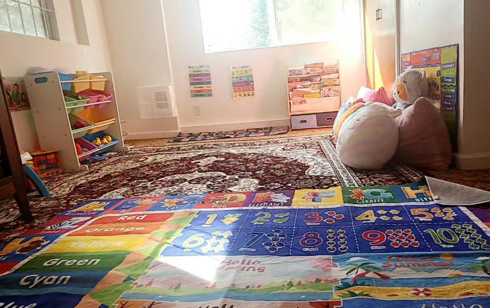 Educational playroom with alphabet and number floor mat and toy storage