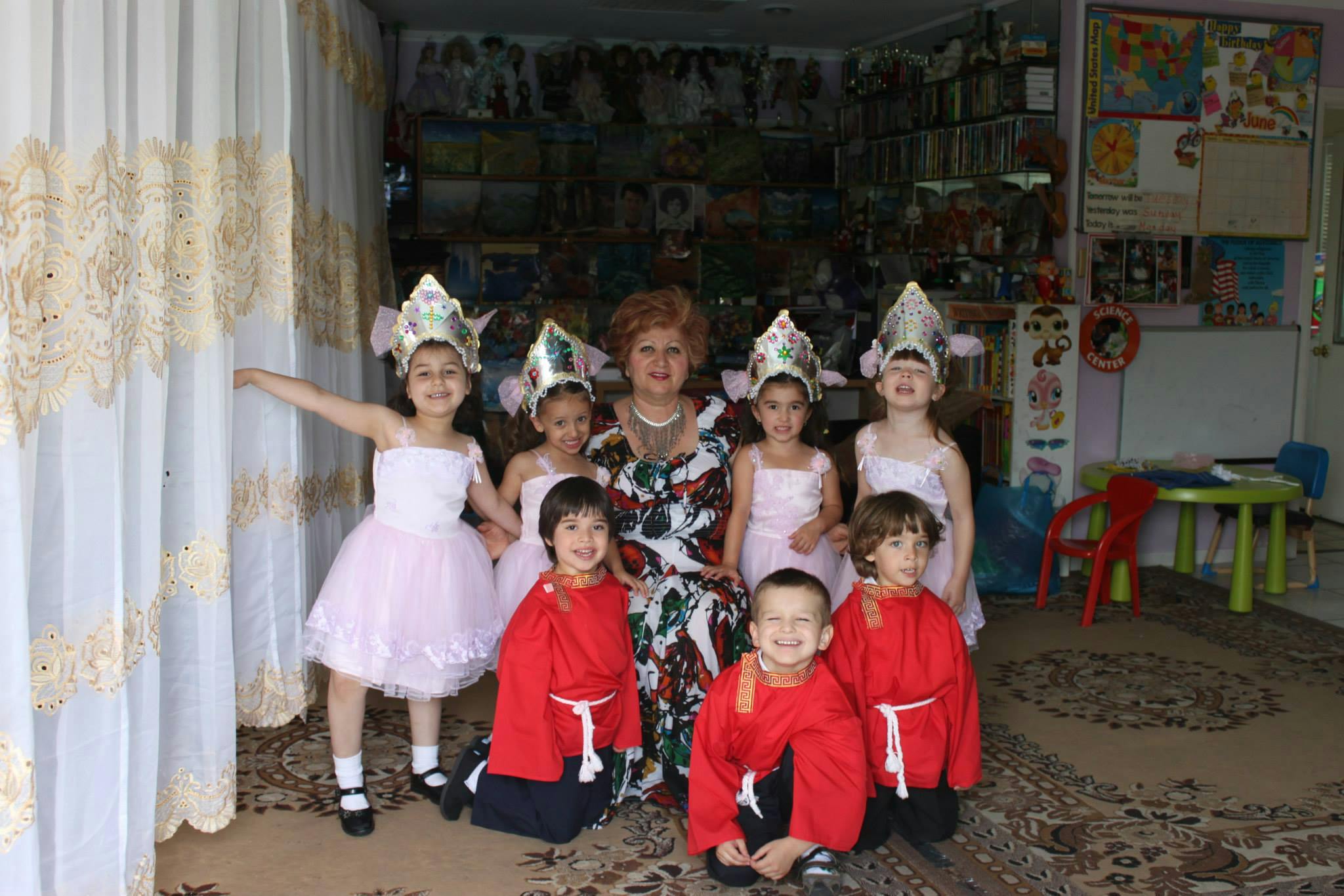 Person with five children in costumes and two children in red robes
