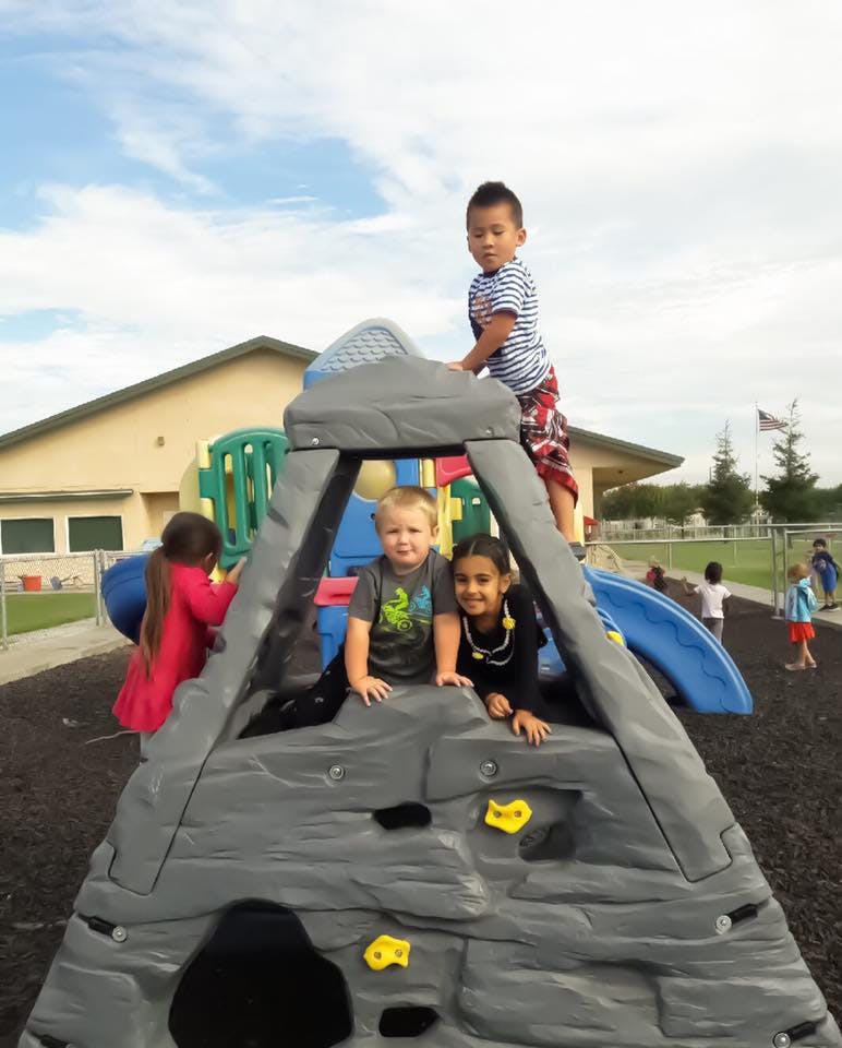 Children playing on a climbing structure at a playground