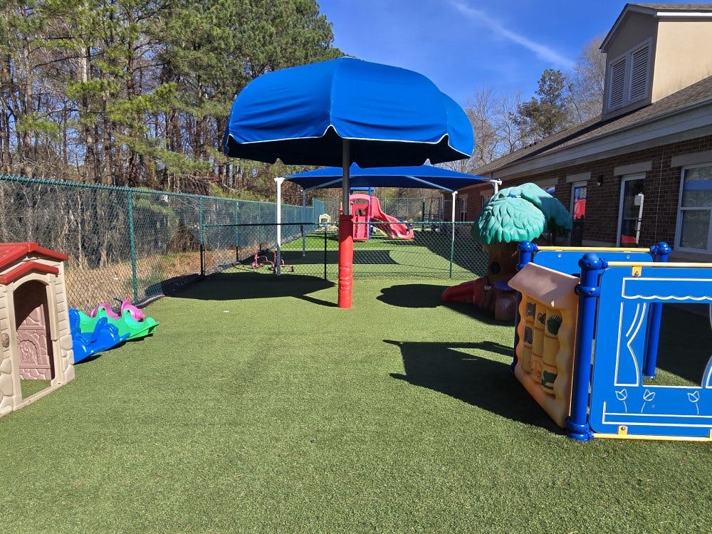 Outdoor playground with artificial turf and colorful play structures