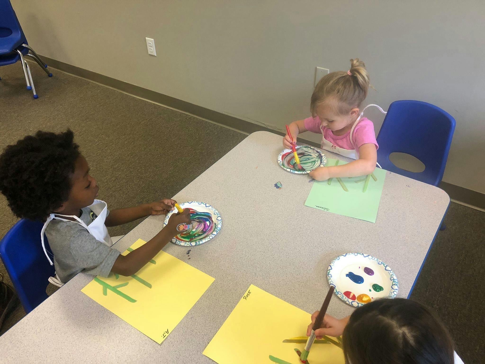 Children painting at a table