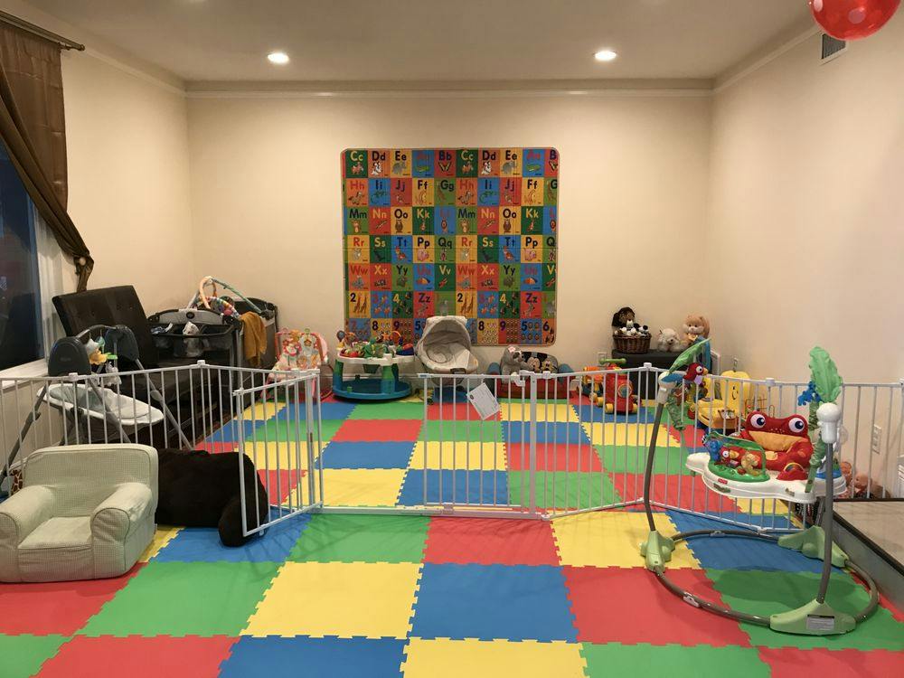 Playroom with colorful floor mats, baby gates, and various toys