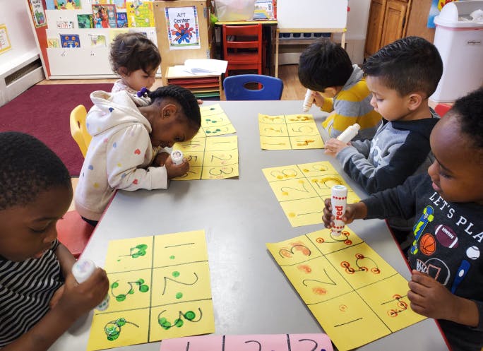 Children doing an art activity at a table