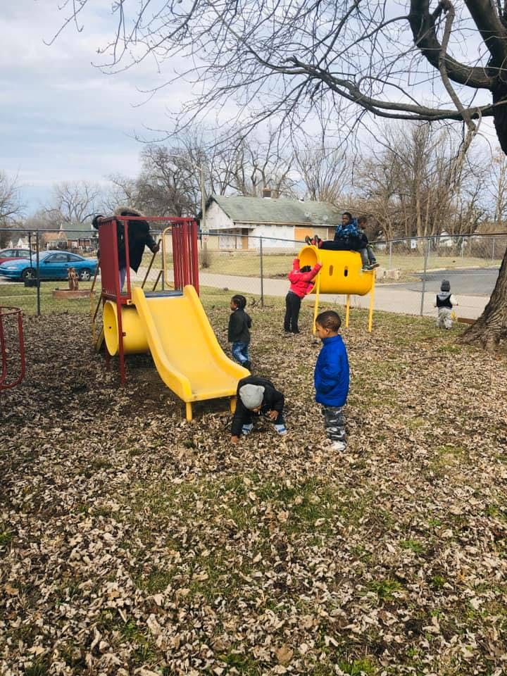 Children playing on a playground with slides and climbing structures