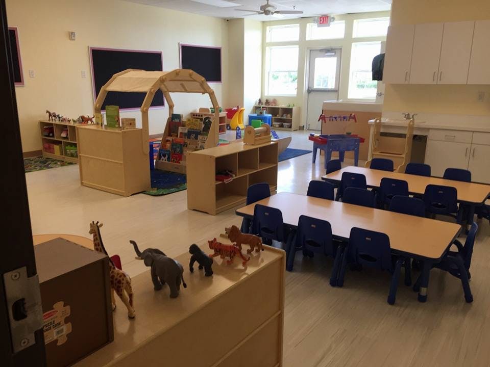 Classroom with tables, chairs, and play structures