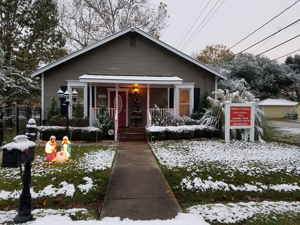 House with snow on the ground and a nativity scene in the yard