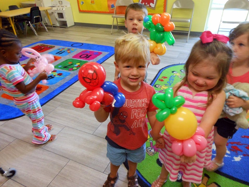 Children holding balloon animals