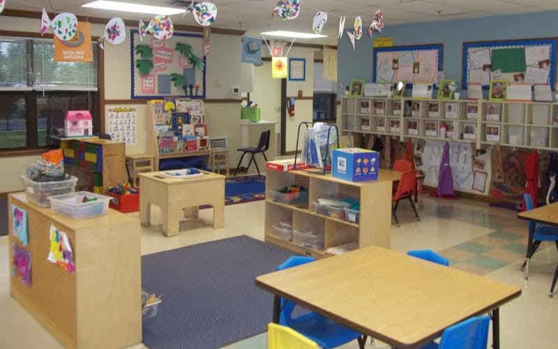 Colorful and organized classroom with small tables, chairs, and learning materials
