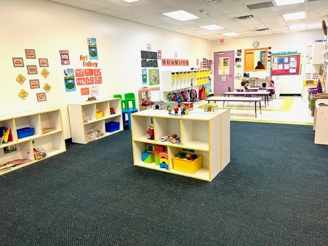 Classroom with shelves of toys and art on the walls