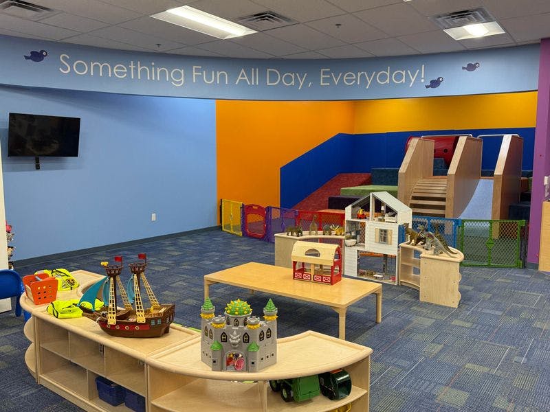 Playroom with a colorful soft play area and various toys