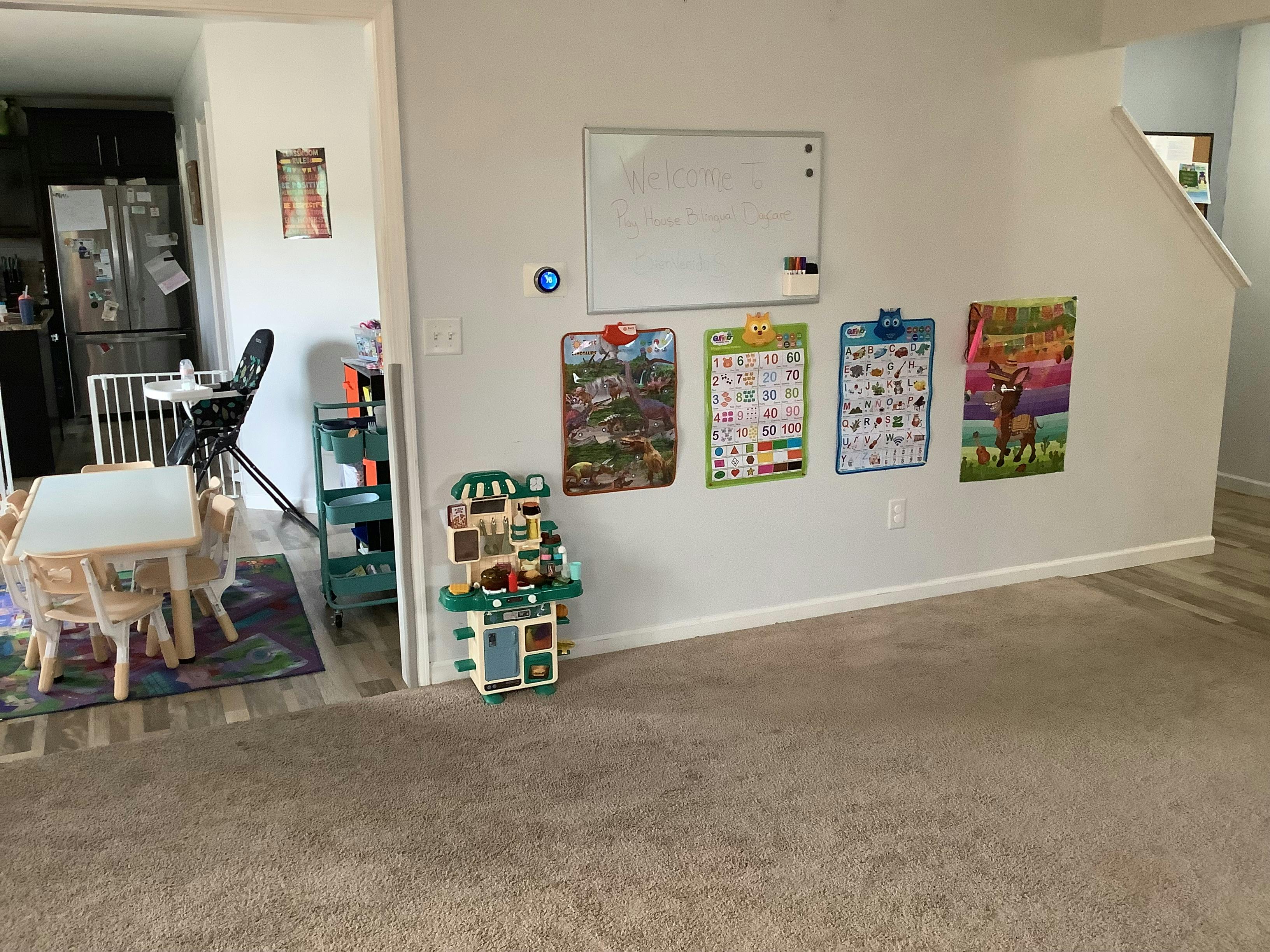Play kitchen and educational posters on a wall