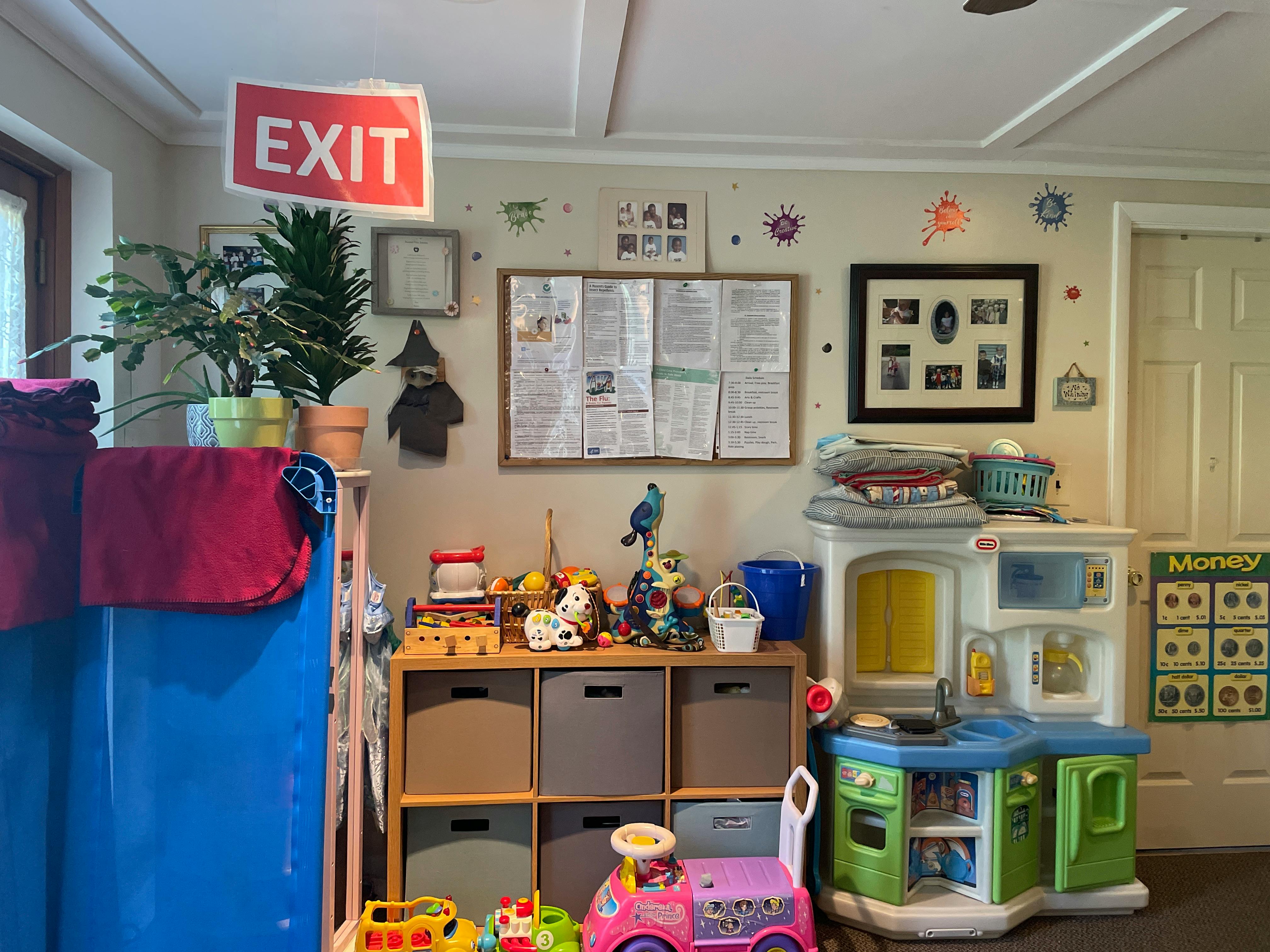 Playroom with toys, storage, and an EXIT sign