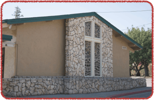 Building with stone facade and cross-shaped window