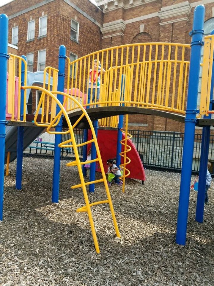 Child standing on a playground structure