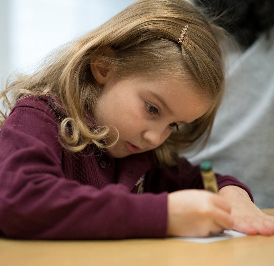 Child drawing with a crayon