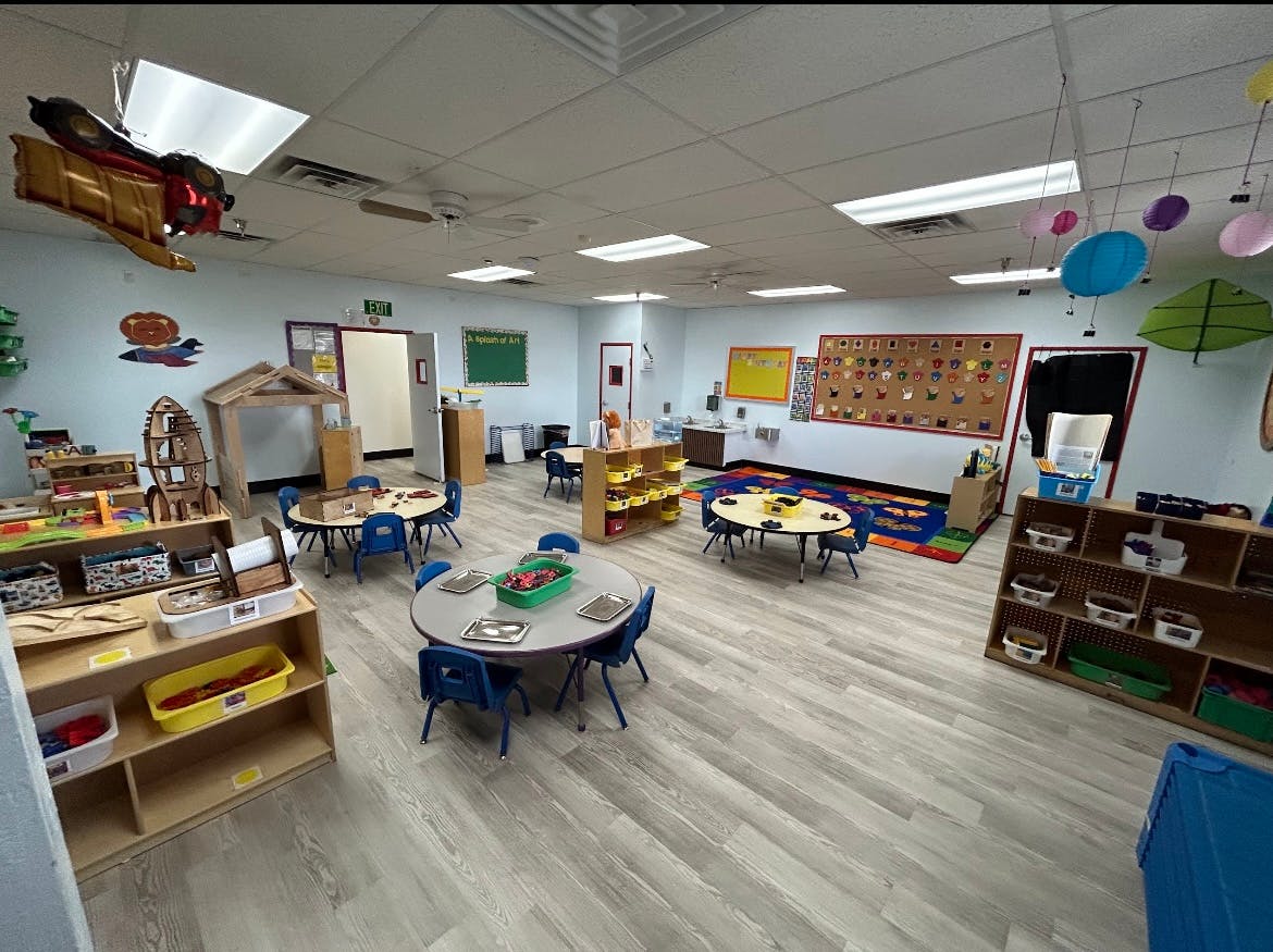 Empty classroom with small tables and chairs