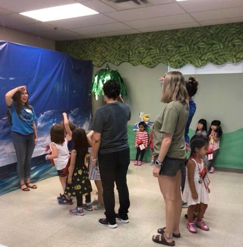 Adults and children standing in a room