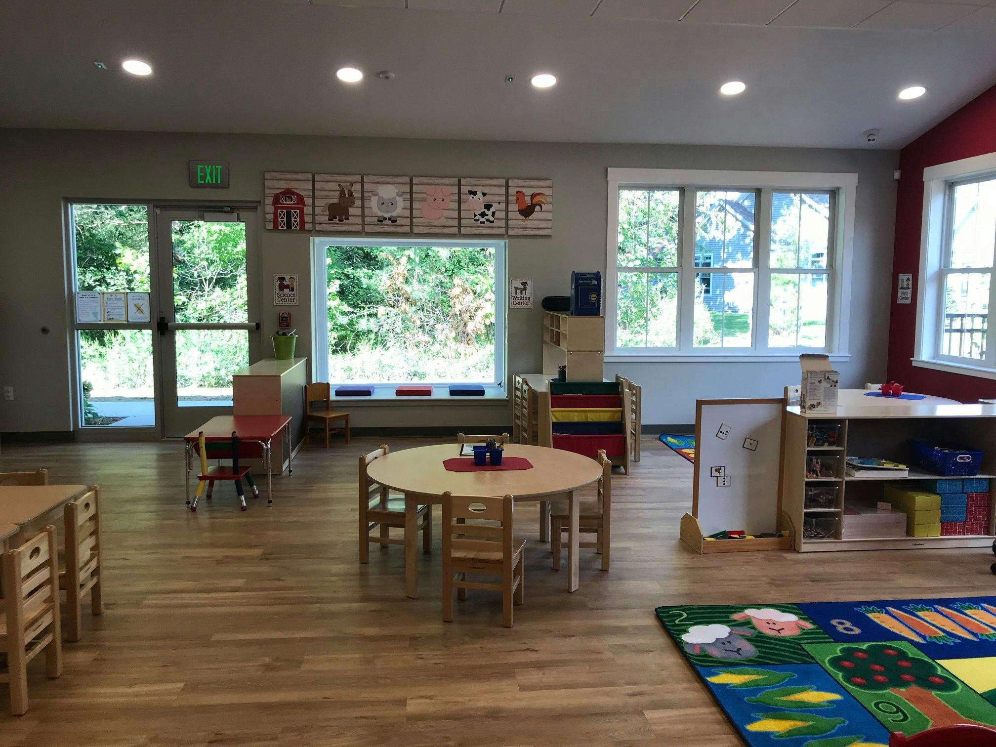 Empty classroom with small tables and chairs