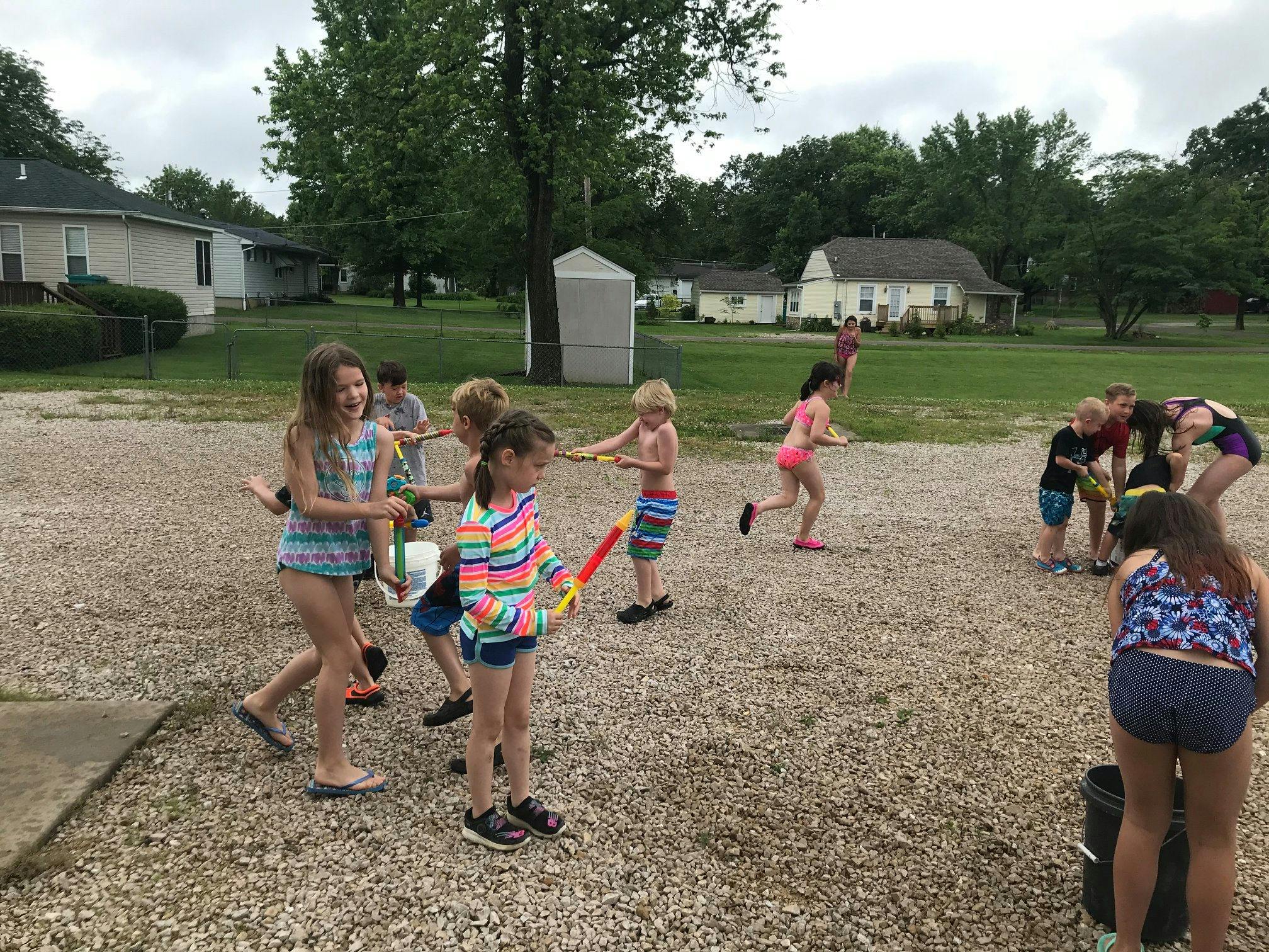 Children playing with water toys outdoors