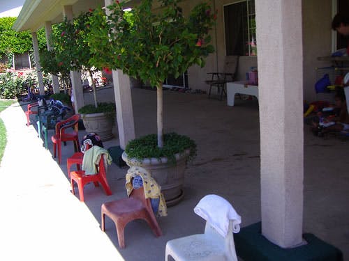 Small chairs with clothes on a covered patio