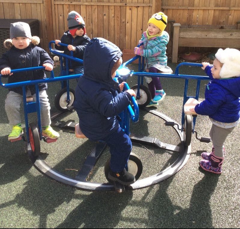 Children playing on a multi-person tricycle