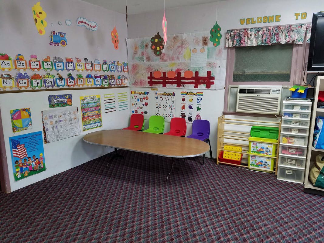 Classroom with a large oval table and colorful chairs