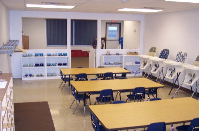 Classroom with tables, chairs, and high chairs
