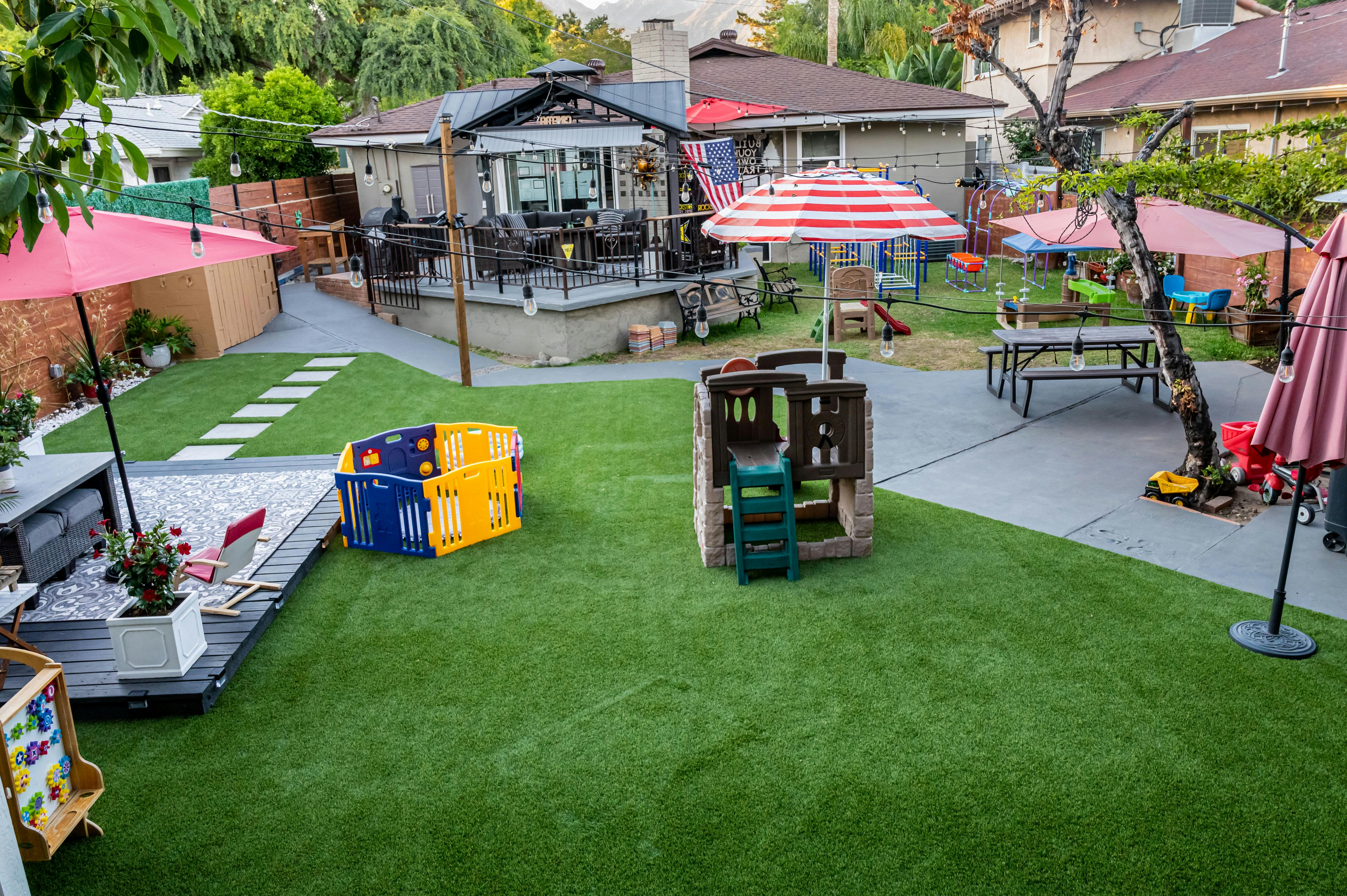 Backyard with outdoor furniture and children play equipment