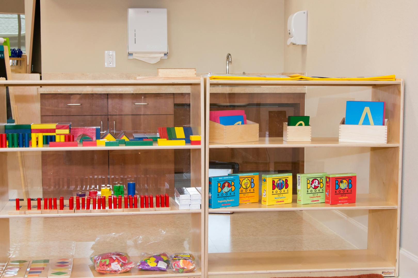 Shelves with colorful learning materials and books in a classroom