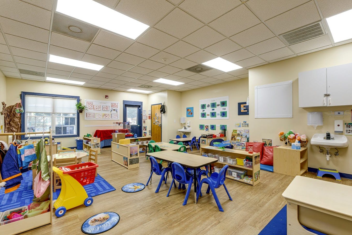 A colorful classroom with small tables and chairs for children, educational decor