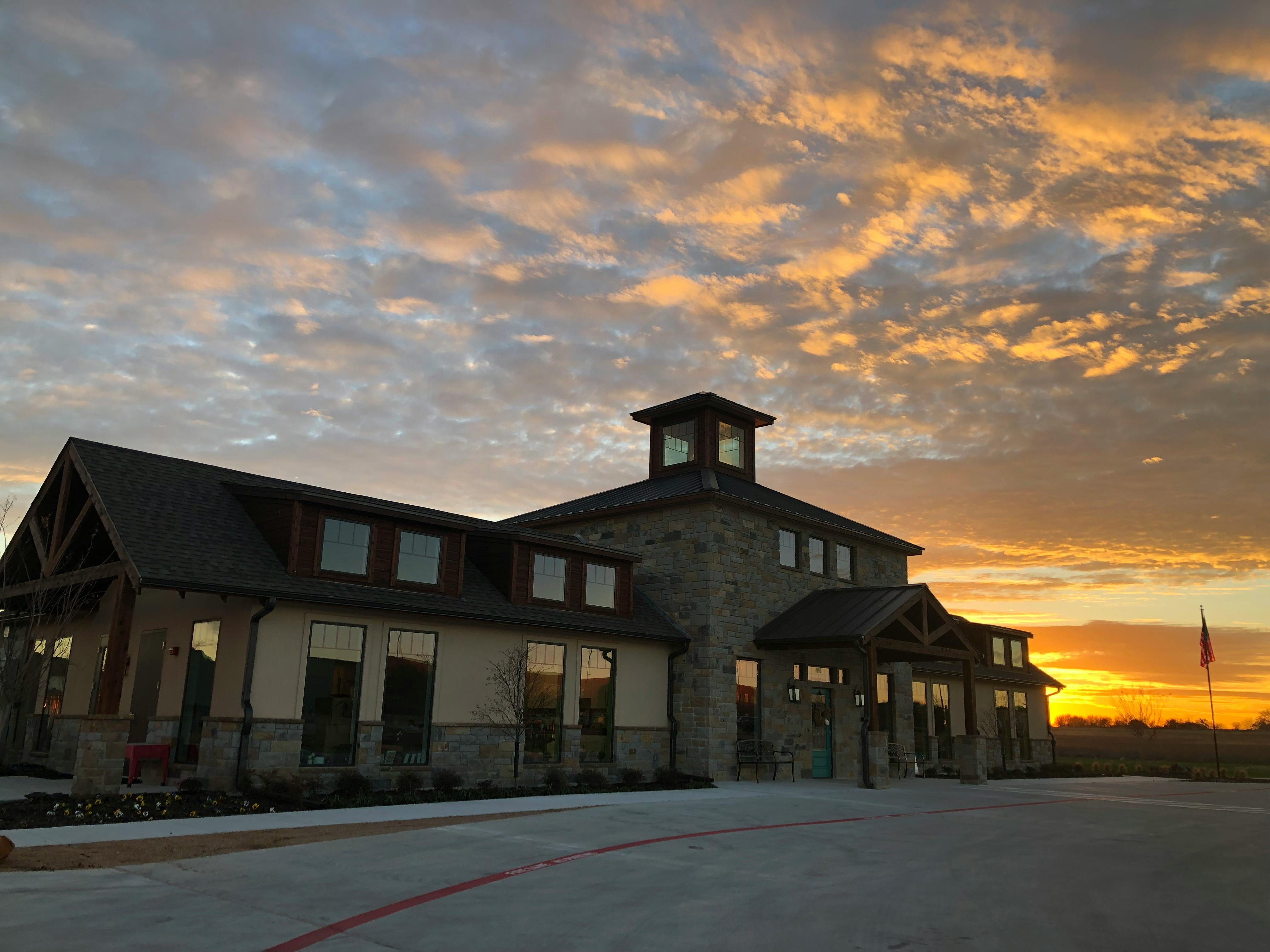 Building with a cupola against a sunset sky