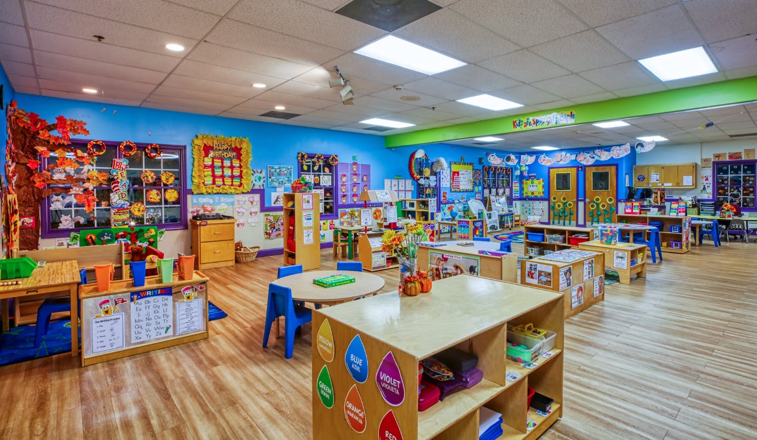 Colorful preschool classroom with various learning stations