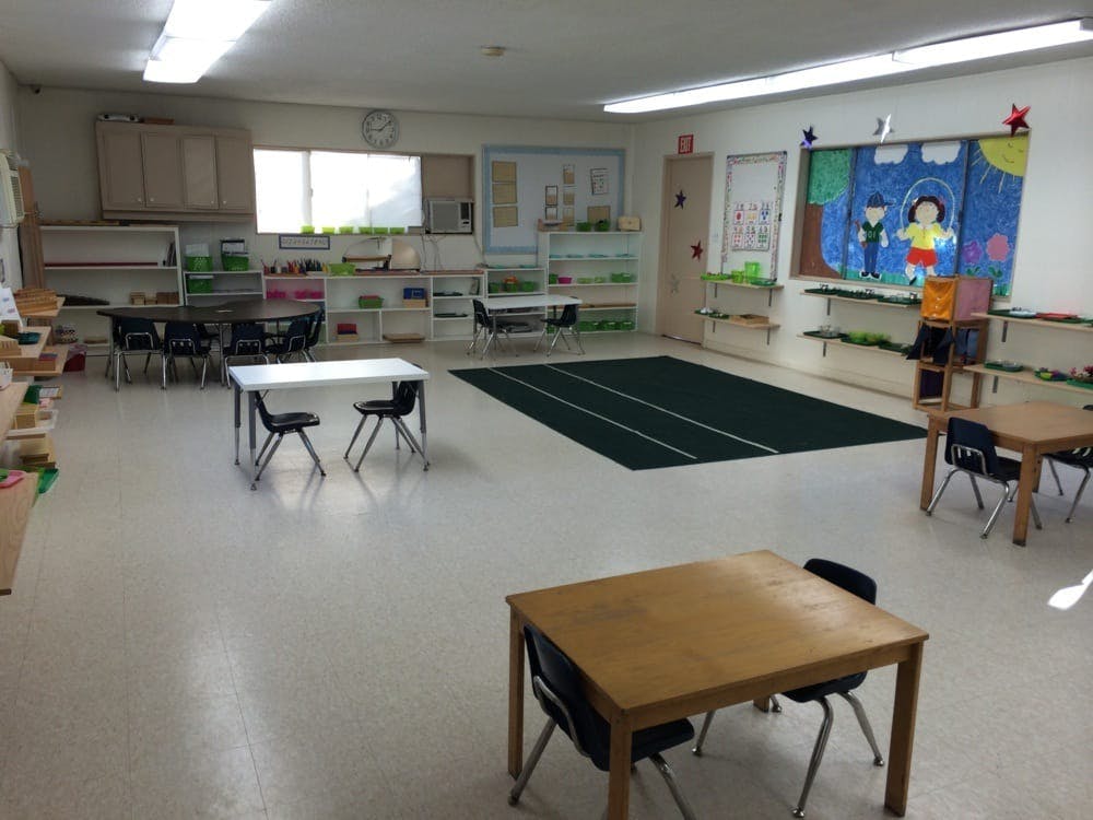 Empty classroom with small tables and chairs